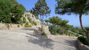A stone-walled building with a sloped roof, surrounded by trees and a clear sky. - Luxury Villa & Spa (Gagliano del Capo)