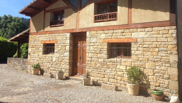 A two-story stone building with a wooden roof and multiple windows. - Spacious 3 Bed Gite, Aude, Pool, Hot Tub, Free Wi-fi, Games Room, Pet-Friendly! (Arques)