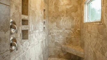 Enjoy a refreshing shower experience with a bench and wall-mounted showerhead.