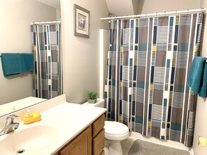 Combined shower/bathtub, hair dryer, towels, toilet paper