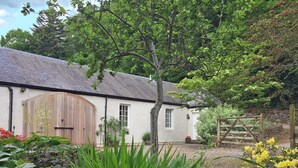 A white building with a large wooden door and a window. - Very spacious rural retreat, walk to Crieff — Couples, Families, Pets Welcome. (Crieff)