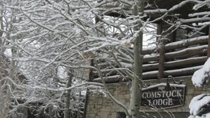A stone building with a sign reading "Comstock Lodge".