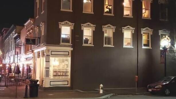 A multi-story building with illuminated windows, a corner storefront, and a fire hydrant on the sidewalk. - Beautiful, remodeled penthouse in Lebanon Ohio, between Dayton and Cincinnati (Lebanon)