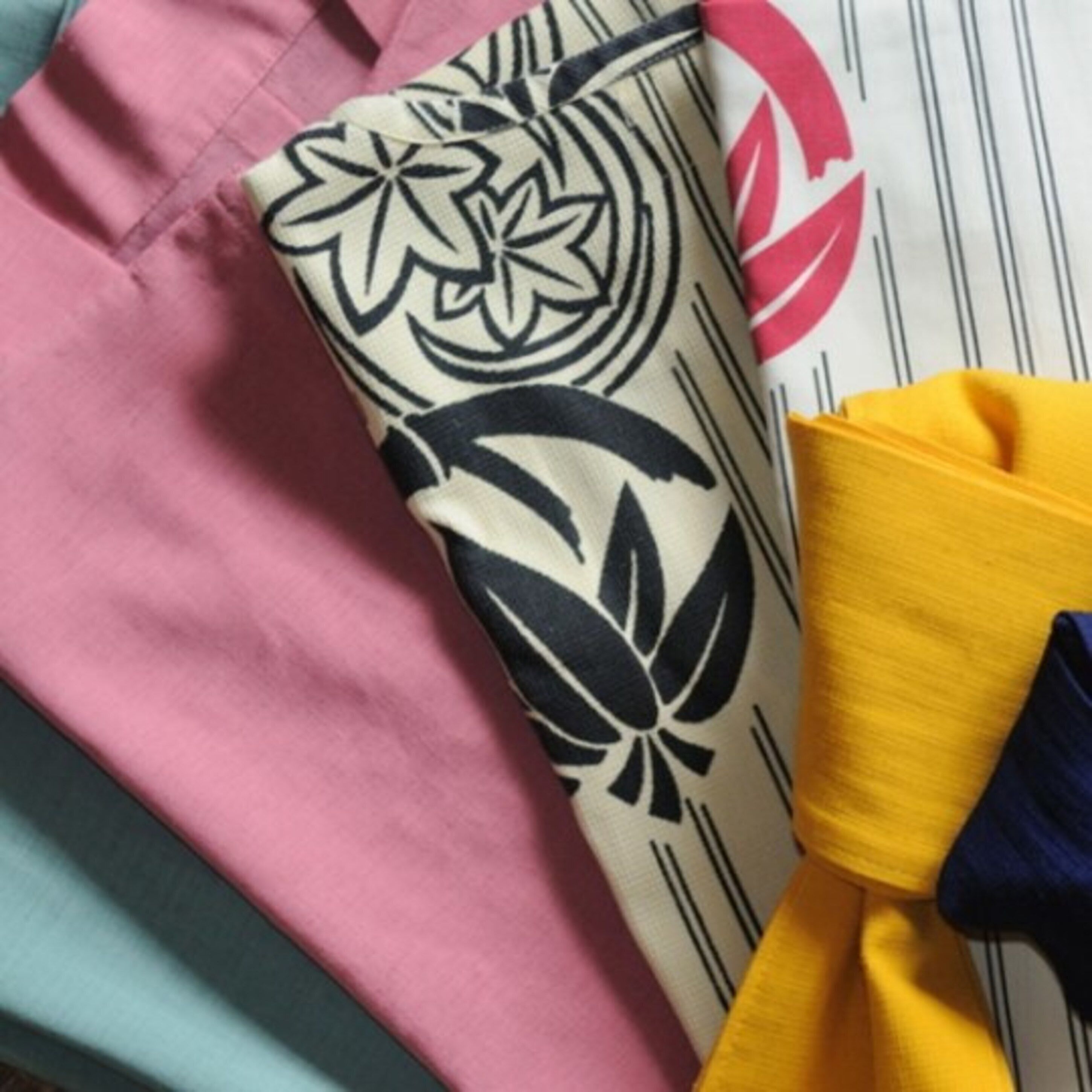 A close-up of a patterned fabric with floral designs and stripes.