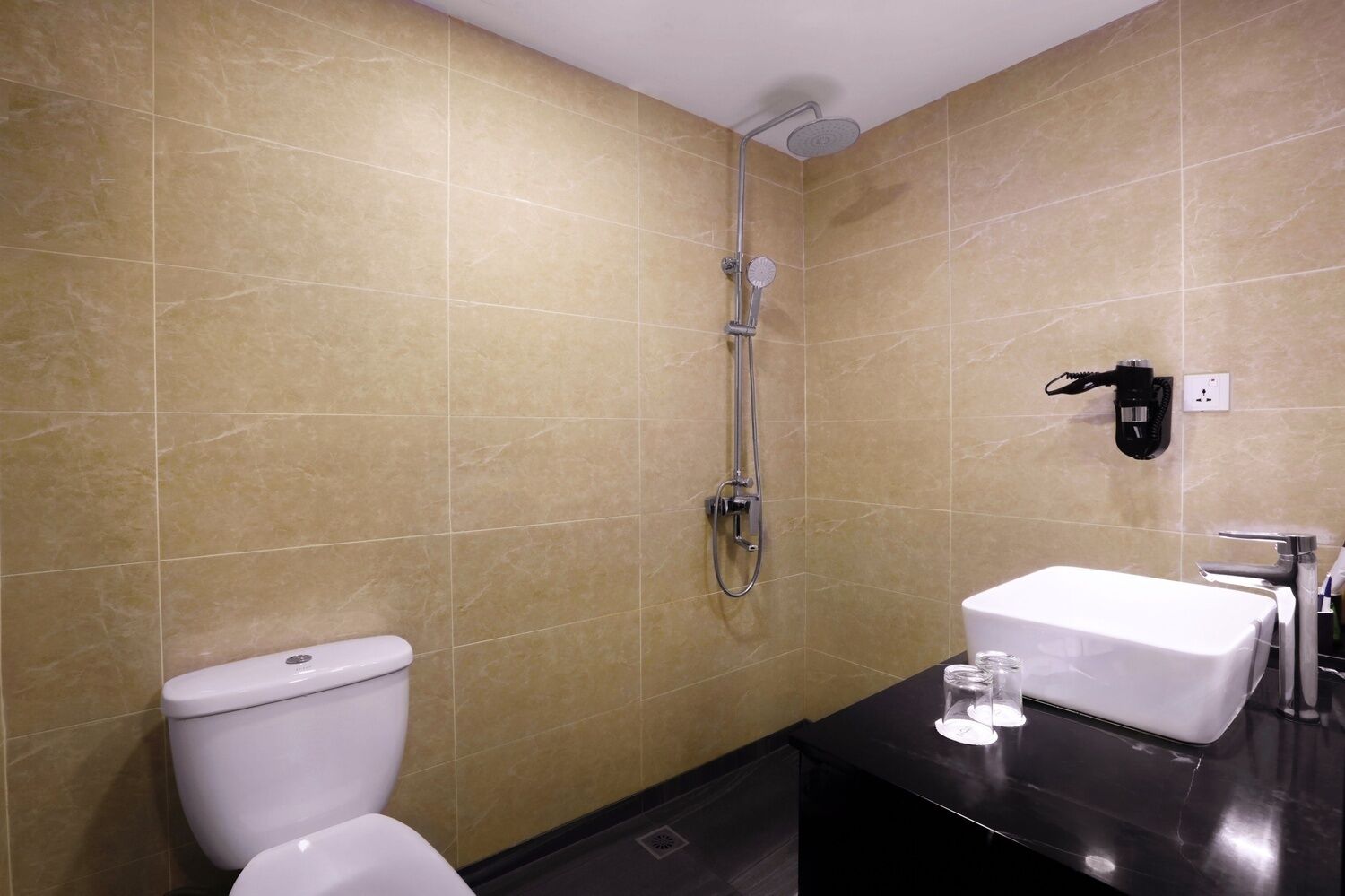 A bathroom with a shower, toilet, and sink.