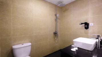 A bathroom with a shower, toilet, and sink.