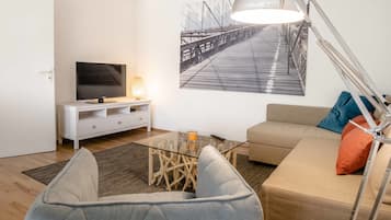Apartamento conforto, 1 quarto | Sala de estar | TV de tela plana