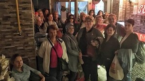 A group of people gathered in a room with a brick wall and a sign that reads "secknfrd". - STS Hotel (Luleburgaz)