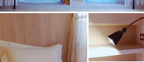 A dormitory with bunk beds, a single bed, a bedside lamp, and a bathroom with a sink and faucet.