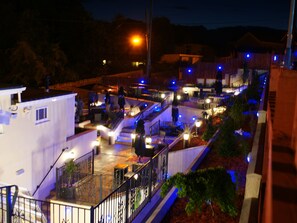 A rooftop terrace with outdoor seating, railings, and a view of the surrounding area. - The Fountain Inn (Swansea)