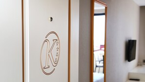 A hotel room with a door featuring a monogrammed design. - Kubalic Hotel (Ordu)