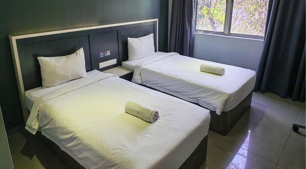 A hotel room with two single beds, each with a pillow and a rolled towel. - Hotel 99 - Kota Kemuning (Shah Alam)