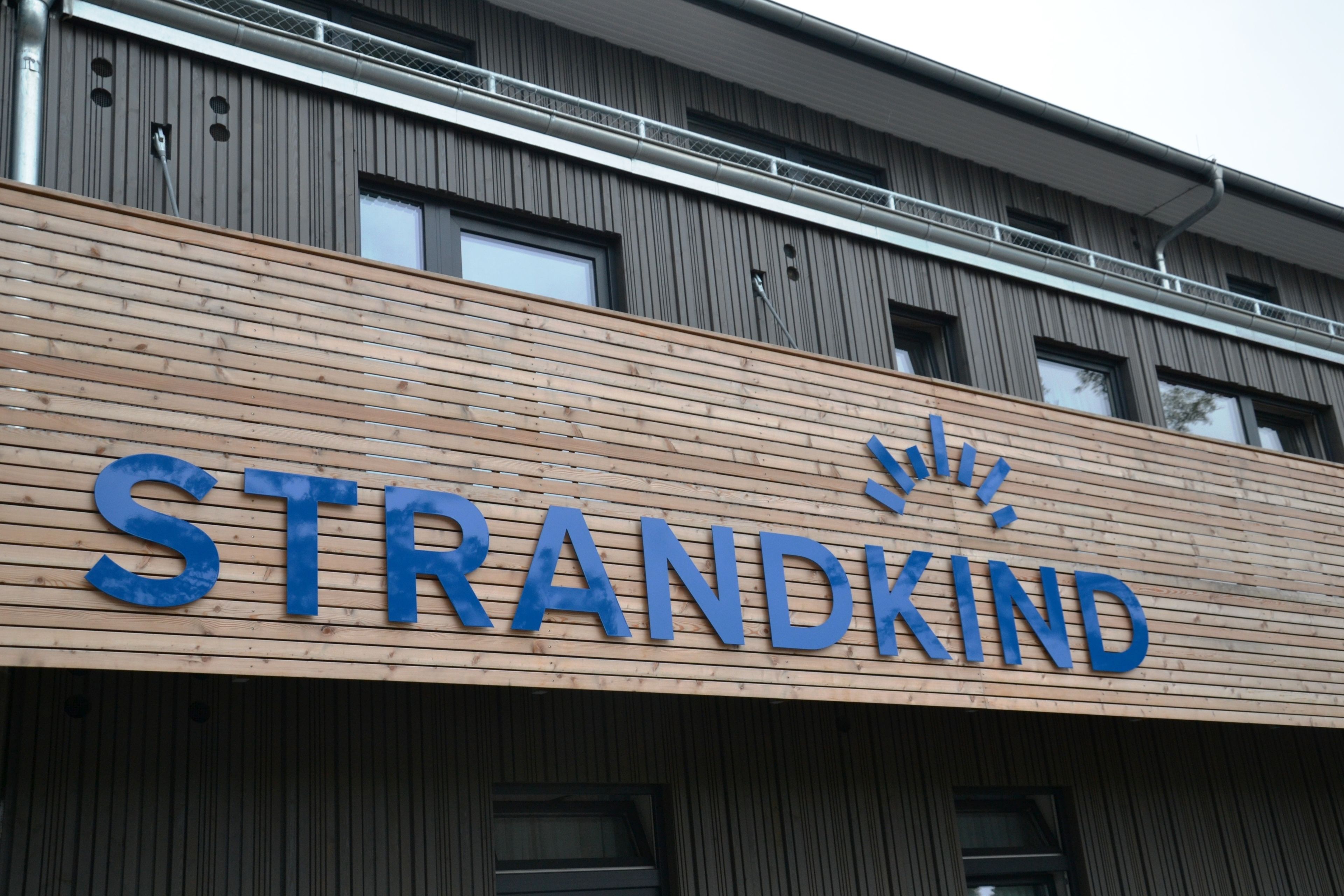 Un edificio con un letrero que dice "STRANDKIND".