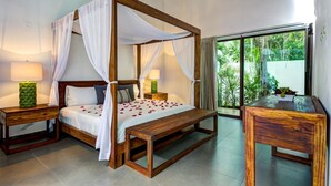 A four-poster bed with white linens and a canopy, flanked by wooden nightstands with lamps, in a room with a large glass door leading to a garden. - Villa Amore 4 bedroom house sleeps 8 (Tulum)