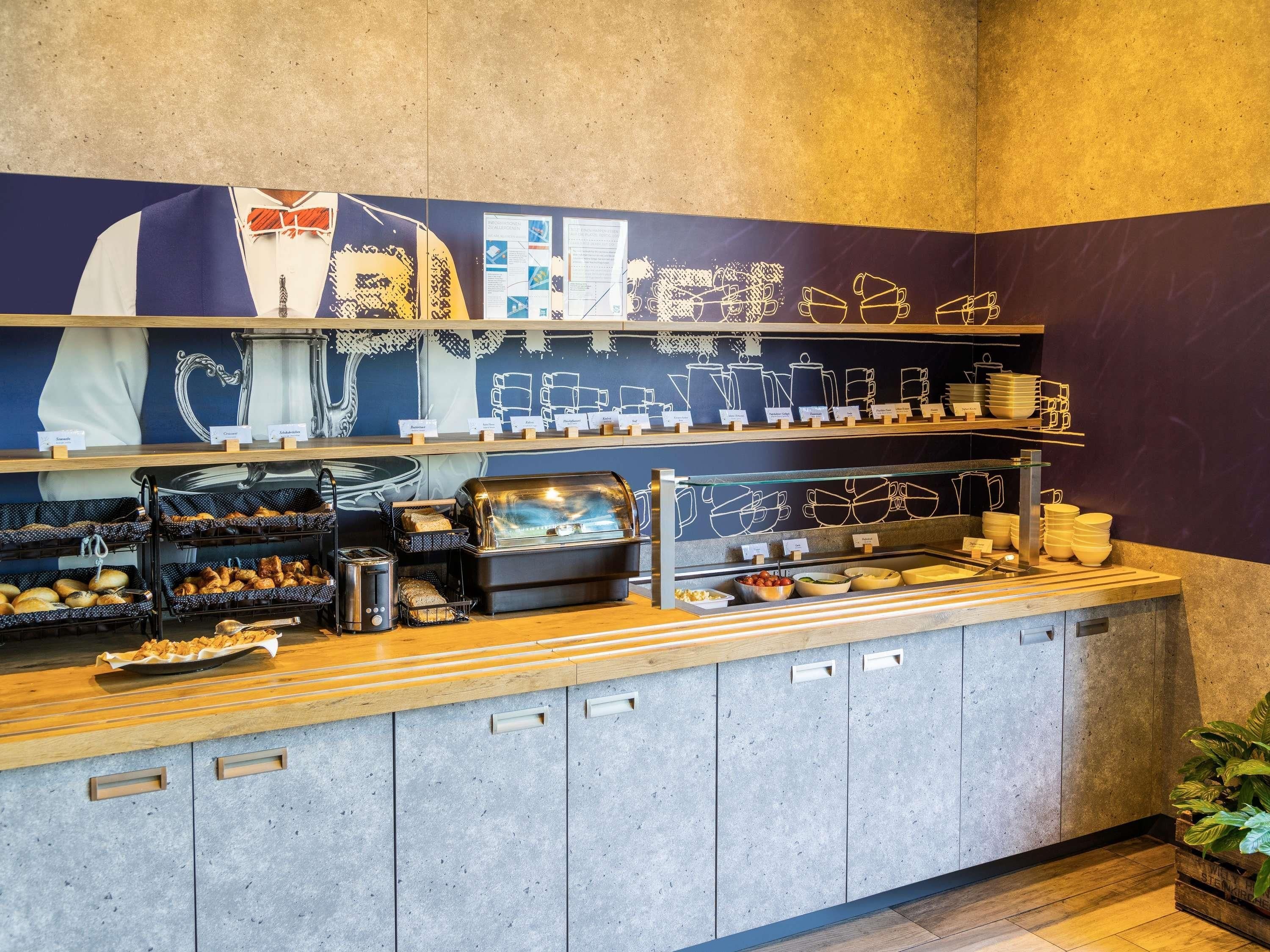A breakfast buffet with various food items and coffee machines.
