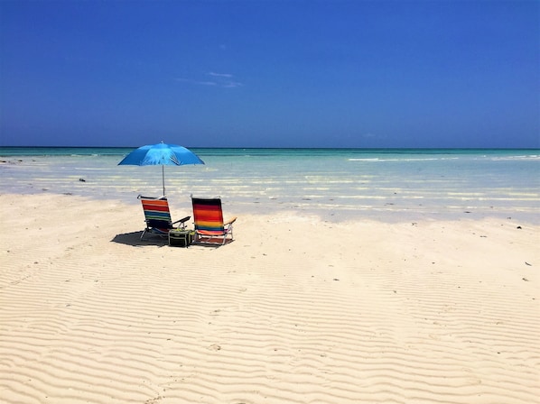 On the beach, sun loungers, beach towels