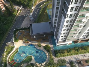 A high-rise building with a rooftop pool and a playground. - Little Home at Green Residence Cheras (Cheras)