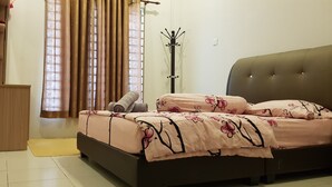 A bedroom with a bed, a coat rack, and a window with curtains. - Fahaz Taiping Homestay (Taiping)