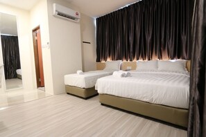 A hotel room with two beds, a large window with dark curtains, a wall-mounted air conditioner, and a mirror reflecting part of the room. - Place2stay Campus Hub (Kota Samarahan)