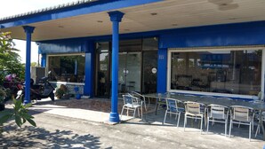 A blue building with a covered outdoor seating area and a number 55 sign. - The Lodge for Cyclists - Hostel (Fangliao)
