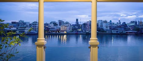 A gazebo with a view of a cityscape across a body of water.