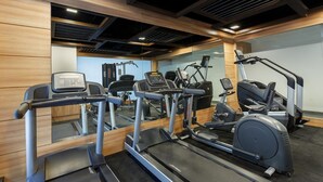 A gym with treadmills, elliptical machines, and weight equipment. - Ginger Hotel Lucknow (Lucknow)