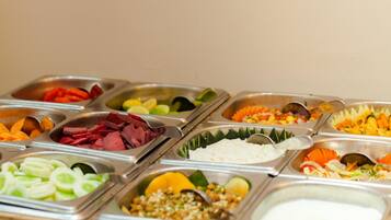 A buffet with various food options including vegetables, meats, and salads.