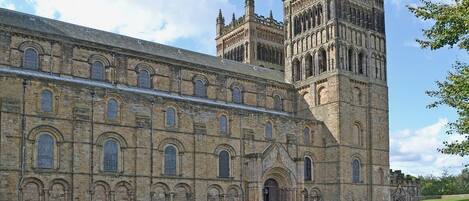 A large historic building with a prominent tower and arched windows.
