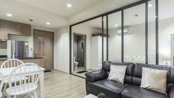 1-Bedroom Condo with Pool View | Living area | Flat-screen TV