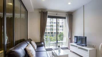 1-Bedroom Condo with Pool View | Living room | Flat-screen TV