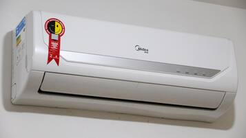 A white Midea air conditioner unit with a red ribbon award on the left side.