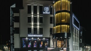 A modern building with a "Noble Restaurant" sign and a "Noble" logo. - Noble Boutique Hotel (Lutsk)