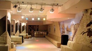A spacious lounge area with a pool table, comfortable seating, and a mural of sailboats on the wall. - Hotel Palace (Cesenatico)