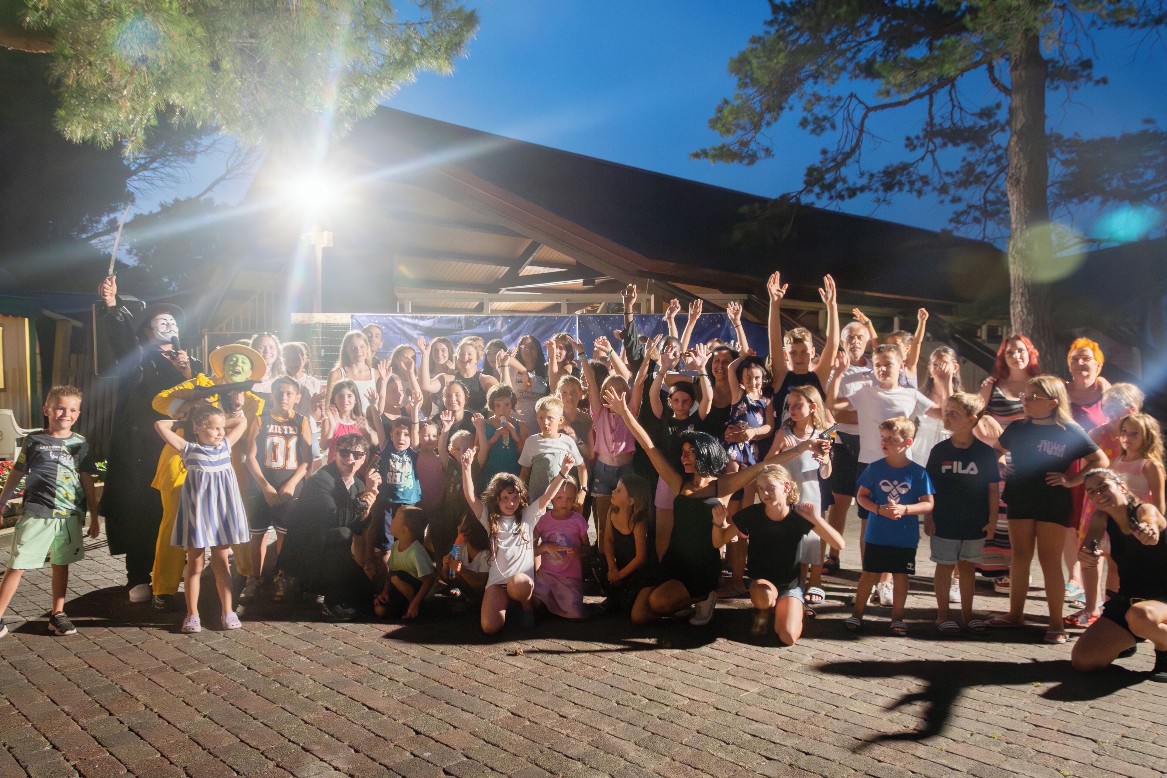 A group of people gathered outdoors, possibly at a public event or celebration.