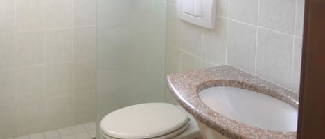 Ein Badezimmer mit Toilette, Waschbecken und Dusche.