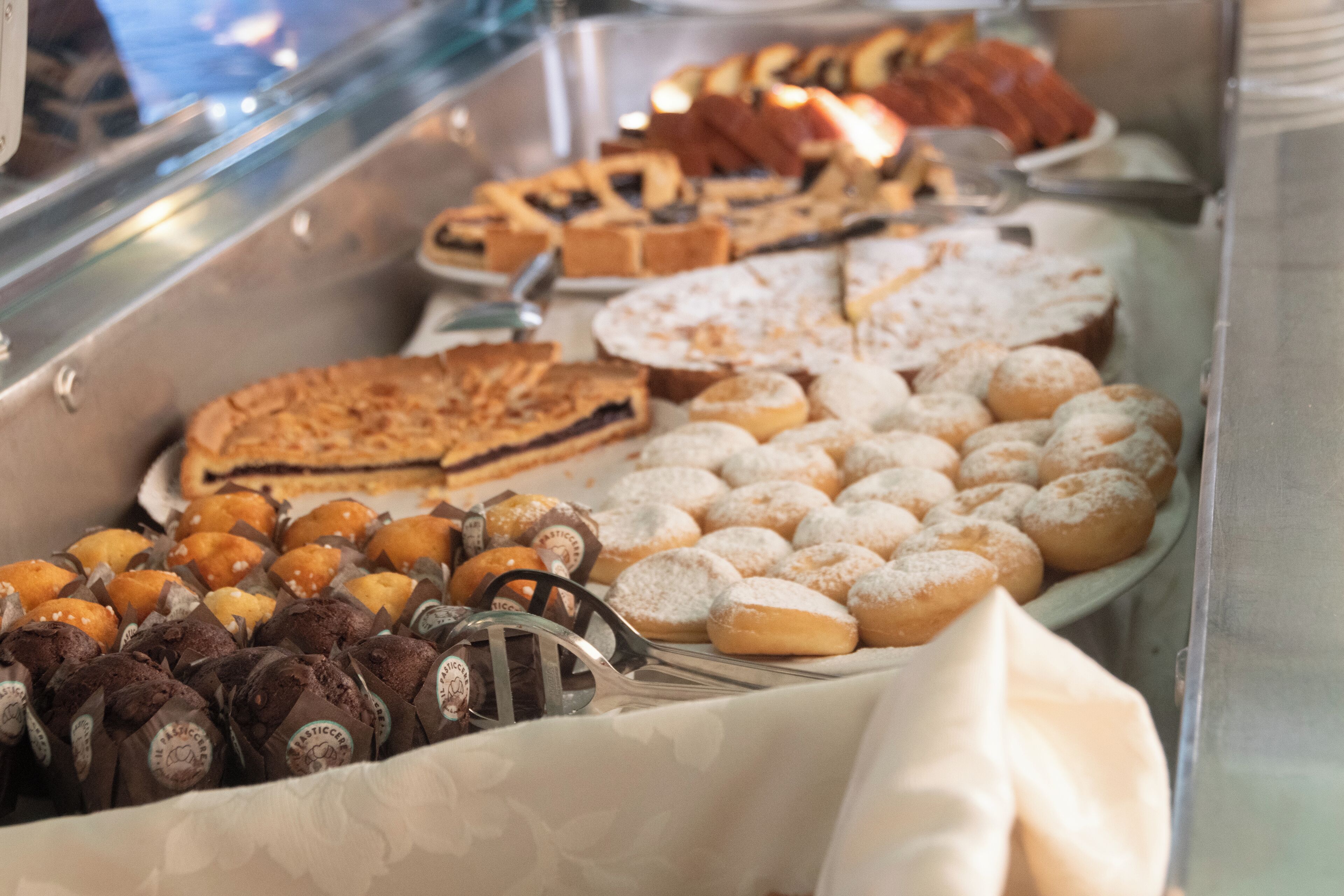 A buffet with various pastries and desserts.