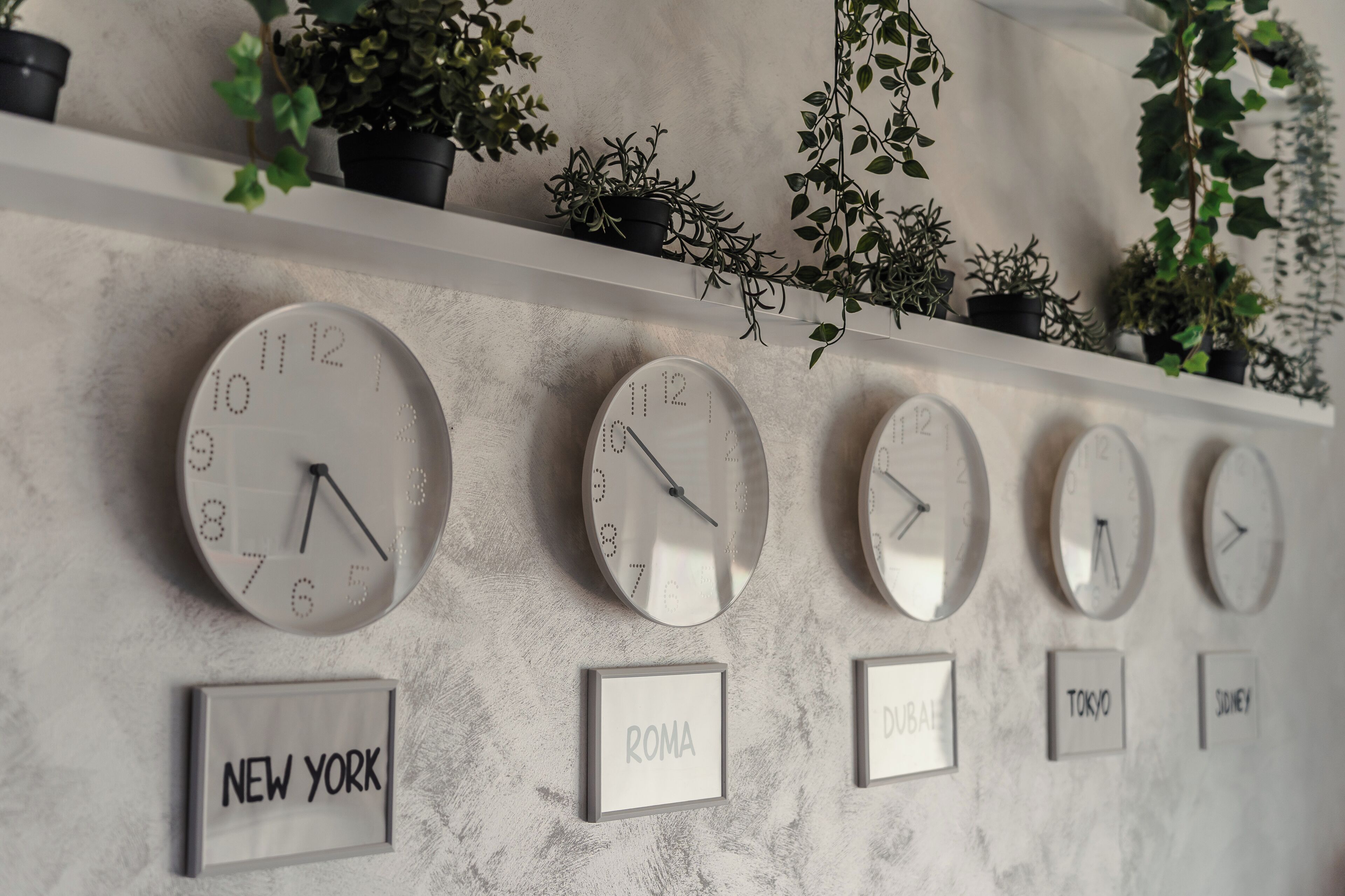 A wall with multiple clocks and labels for different cities.