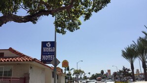 A street view with a motel named 'WORLD MOTEL' and a drive-thru. - World Motel (Lynwood)