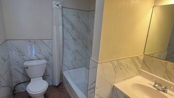 Economy Room | Bathroom | Shower, free toiletries, towels, soap