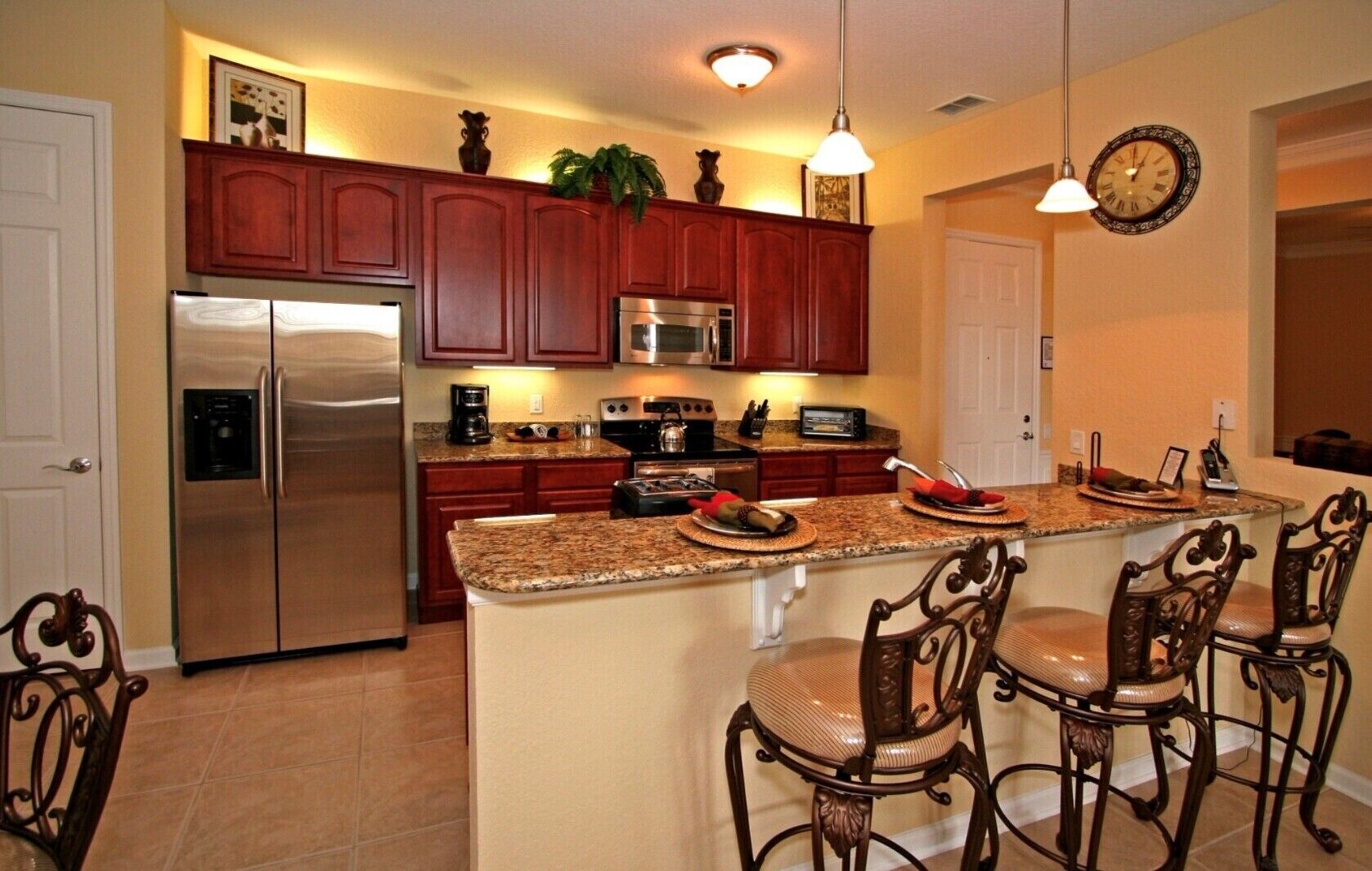 A modern kitchen with a central island, stainless steel appliances, and wooden cabinetry.