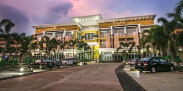 A hotel with a modern design, featuring multiple floors and a prominent entrance.
