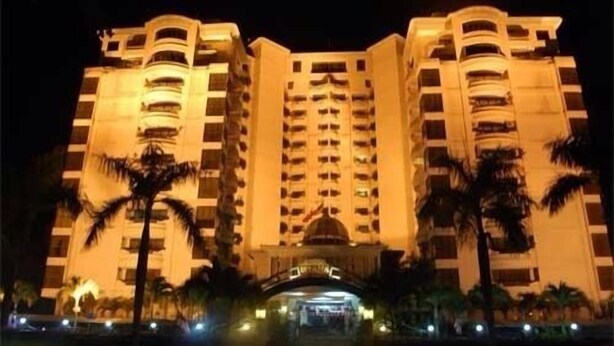 A multi-story hotel with a central entrance and balconies on each floor. - May Condo (Langkawi)