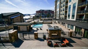 A rooftop pool area with lounge seating and a view of a mountain. - Penthouse Ski-In Ski-Out Above Sheraton 1bd 1.5ba (Steamboat Springs)