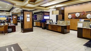 A hotel lobby with a reception desk, seating area, and a large chandelier. - Penthouse Ski-In Ski-Out Above Sheraton 1bd 1.5ba (Steamboat Springs)
