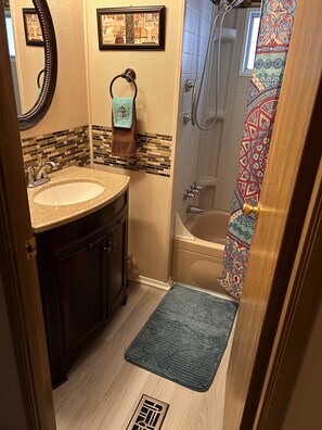Combined shower/bathtub, hair dryer, towels, toilet paper