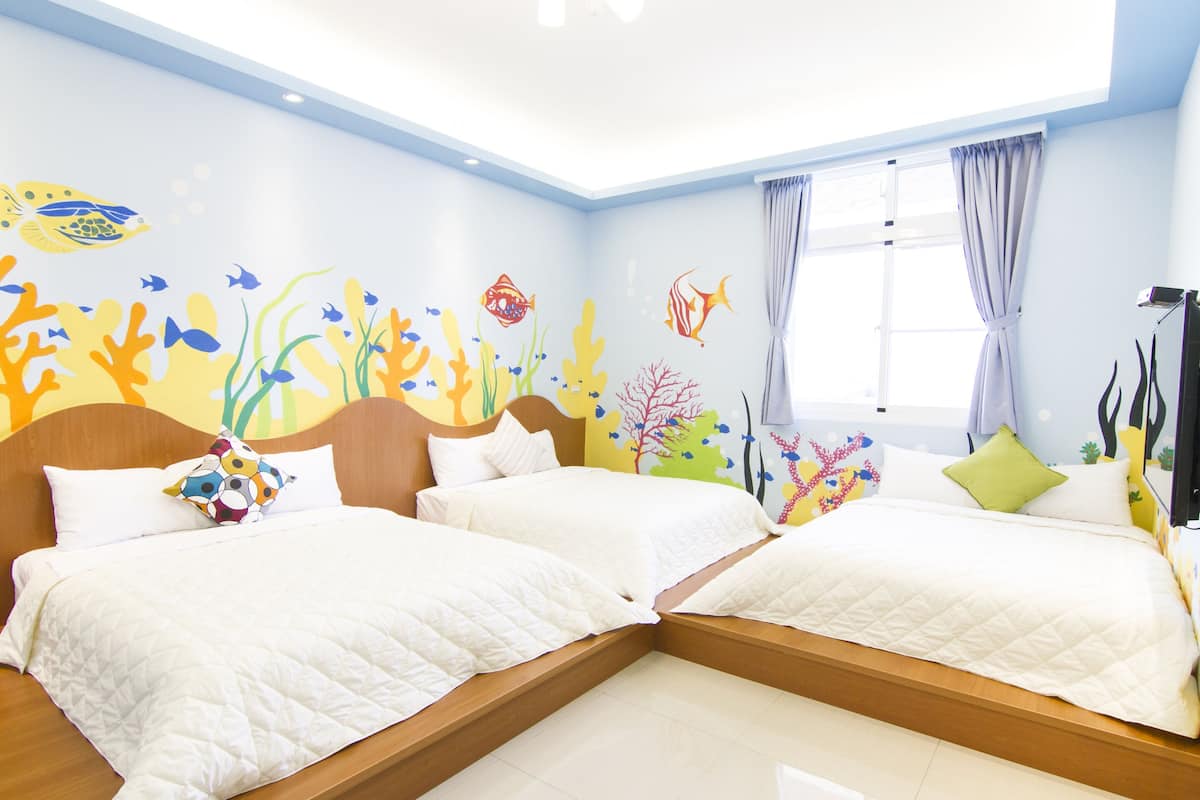 A hotel room with two beds, a large window with curtains, and a ceiling with a skylight.