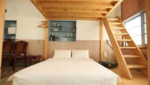 A bedroom with a wooden ceiling, a bed, a desk with a chair, a bookshelf, and a ladder. - Adore Tainan - Adore Space (Tainan)
