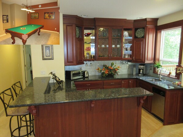 A kitchen with wooden cabinets, a granite countertop, a built-in oven, and a window. - Upscale quiet 2BR suite near downtown -- Pool table -- NW Portland (Portland)