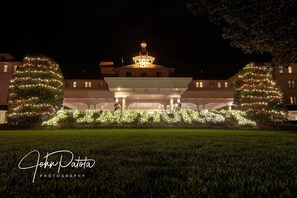 A building with a central dome and two large Christmas trees on either side. -  Cozy 1 bedroom condo in walking distance to the Club, the Cradle & the Village! (Pinehurst)
