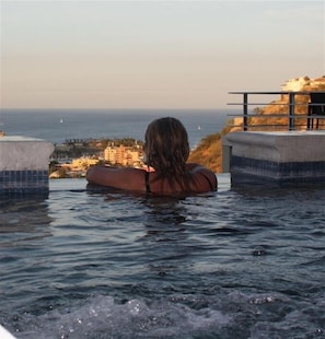 Guests can unwind in a hot tub with breathtaking ocean views.